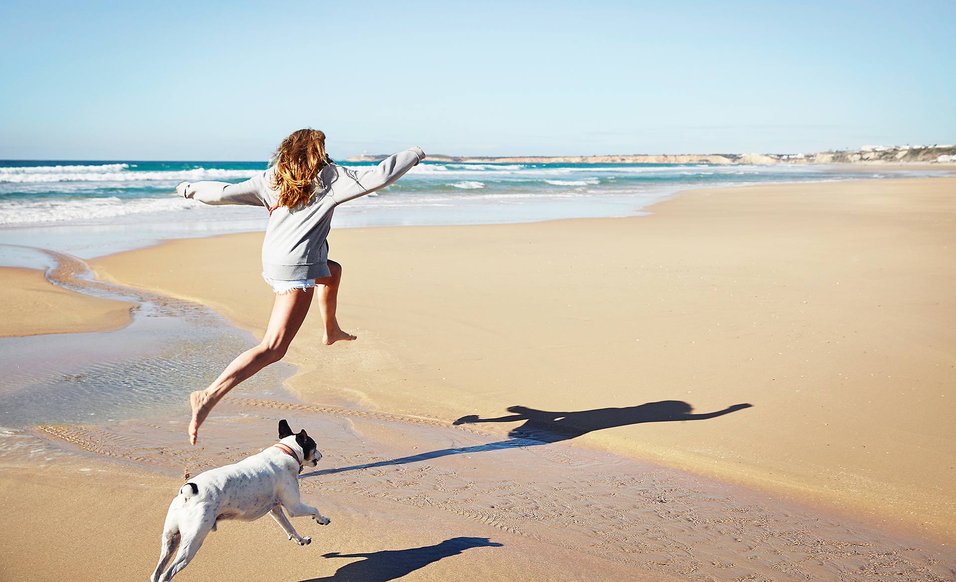 Women leaping with dog