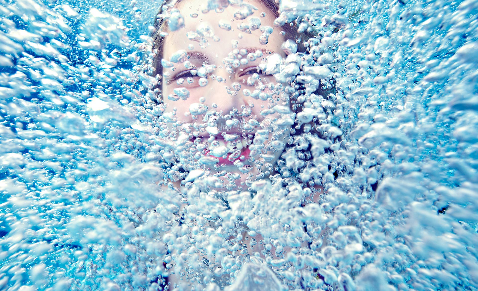 Girl laughing underwater