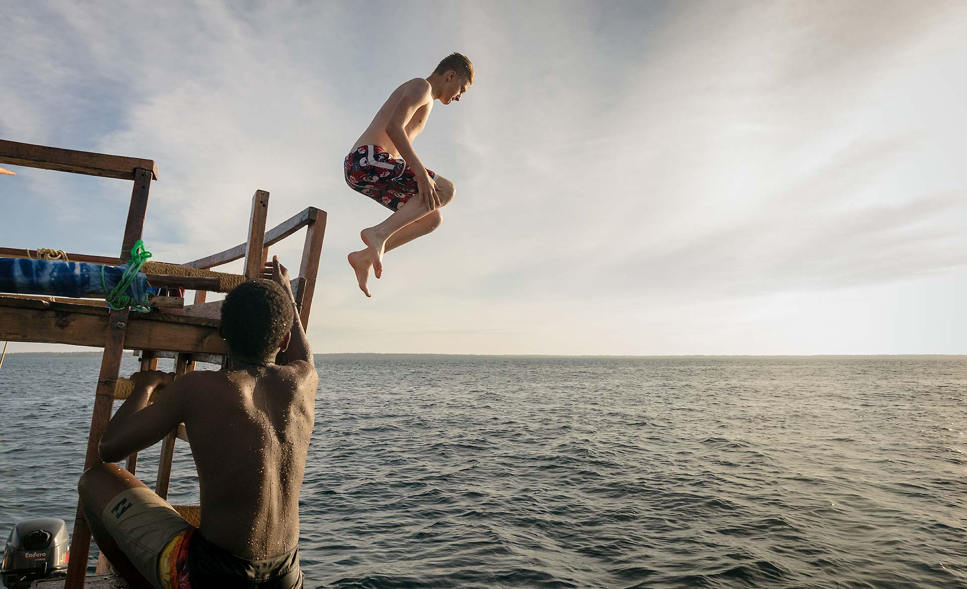 Boy jumping from boat